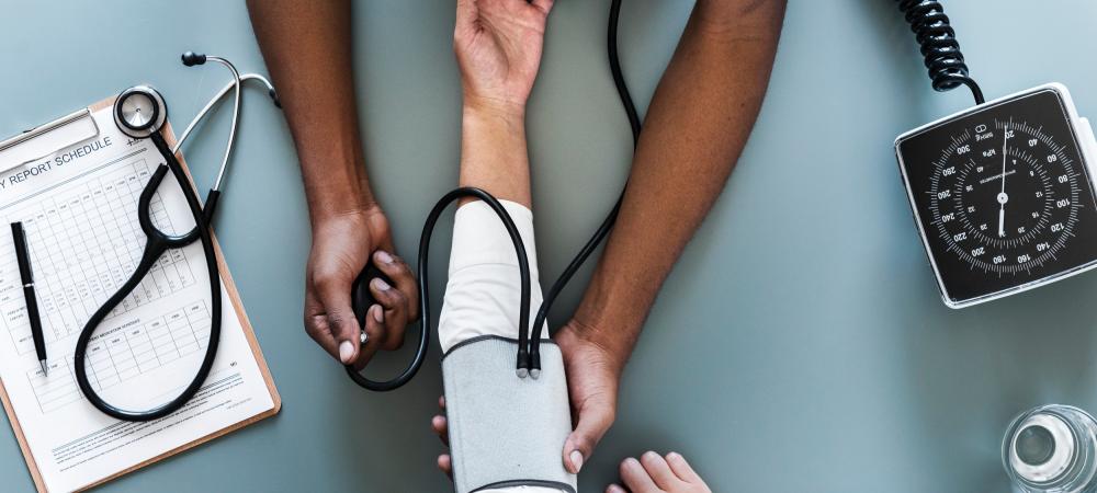 A doctor takes a patient's blood pressure.